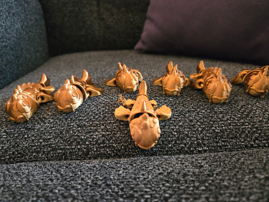 Mini Koi Companions 3D printed articulated figurines – group of golden koi fish figurines displayed on a couch