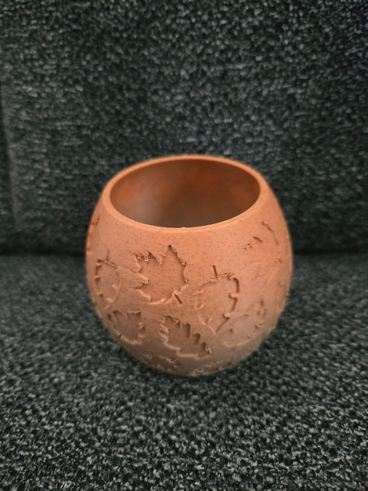 3D printed Falling Leaves Tea Light Vase in terracotta-colored filament with embossed maple leaf design, exterior view