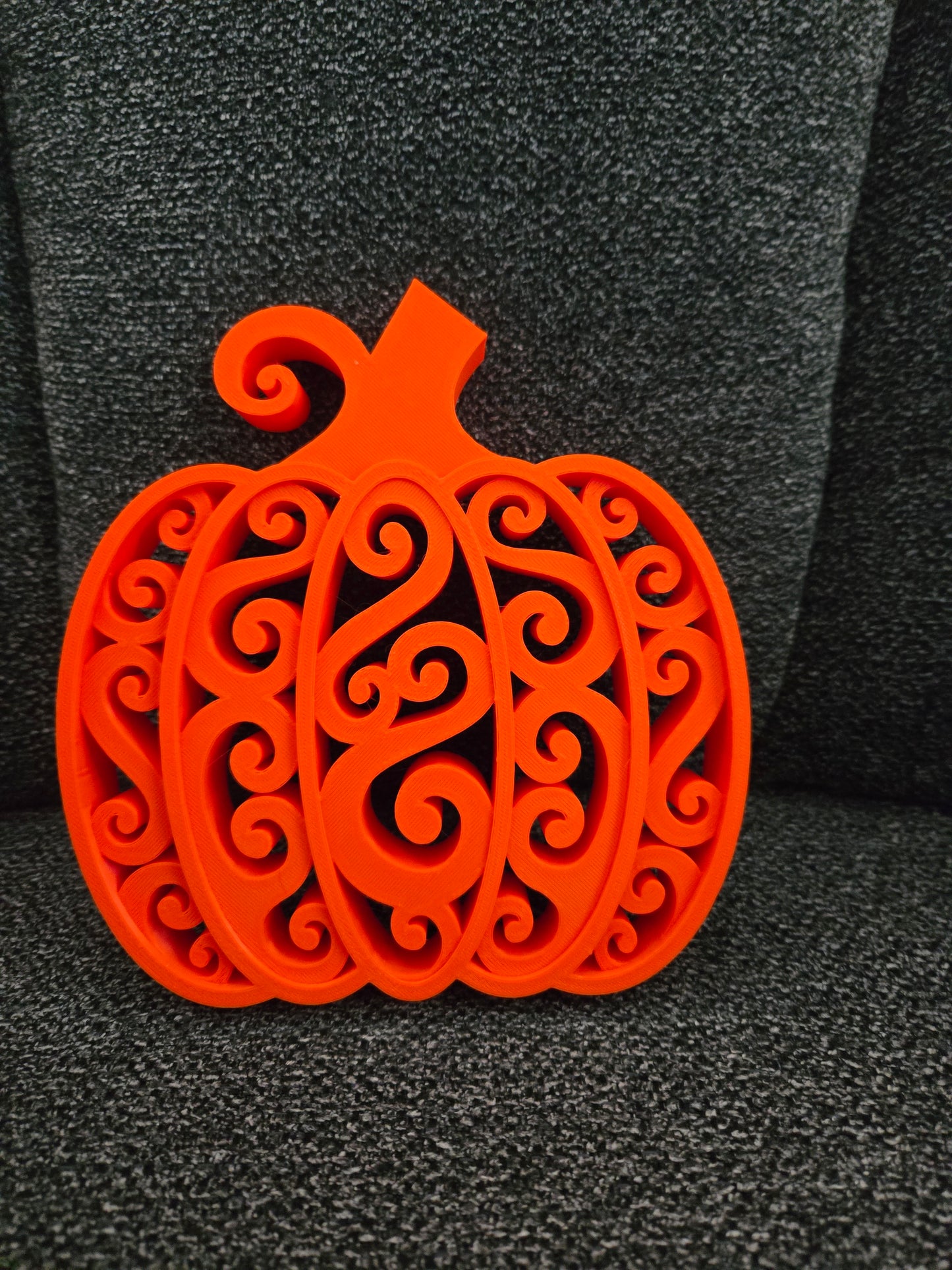 3D printed Swirly Pumpkin in solid orange with intricate filigree swirl design, front view