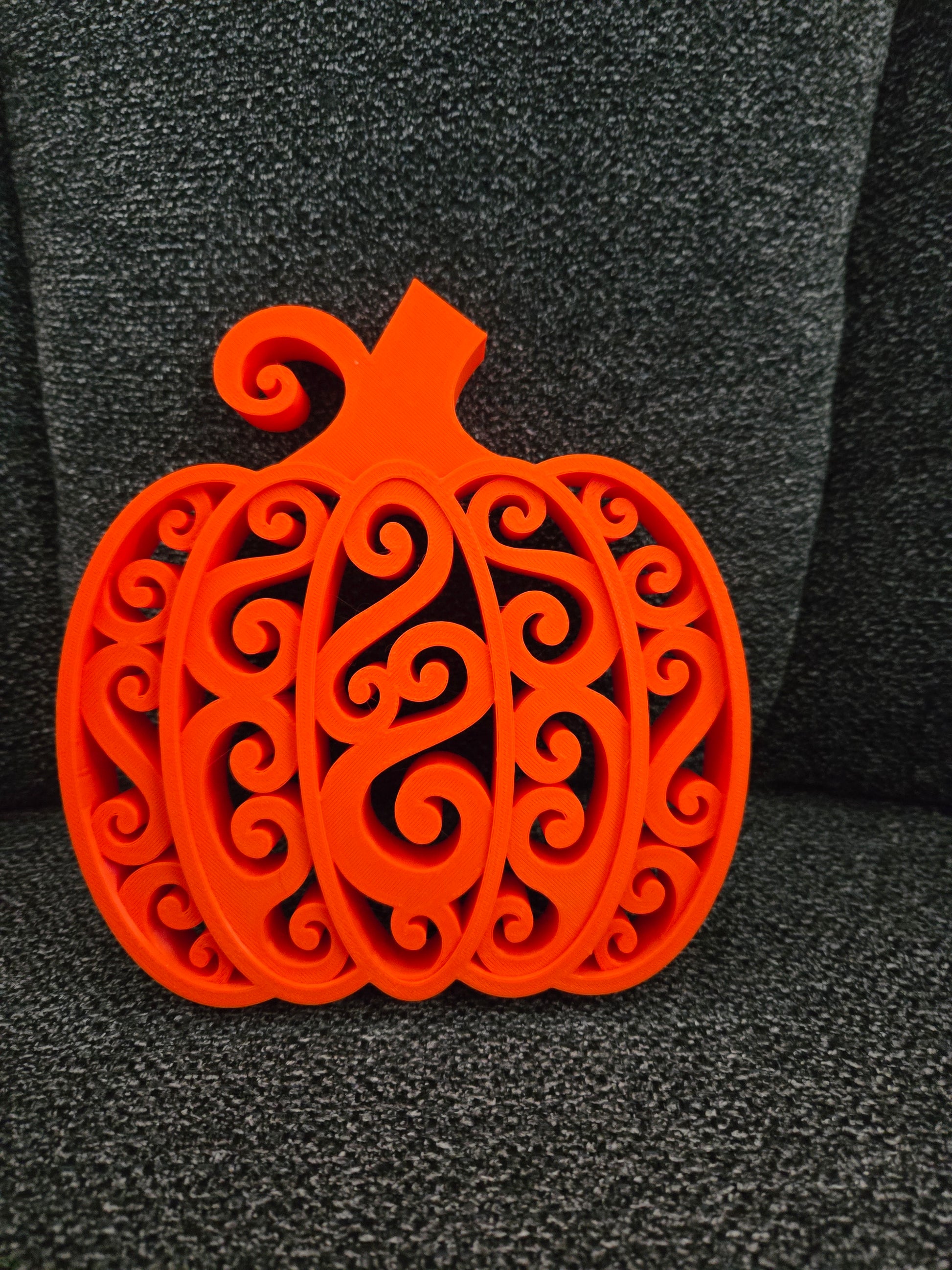 3D printed Swirly Pumpkin in solid orange with intricate filigree swirl design, front view