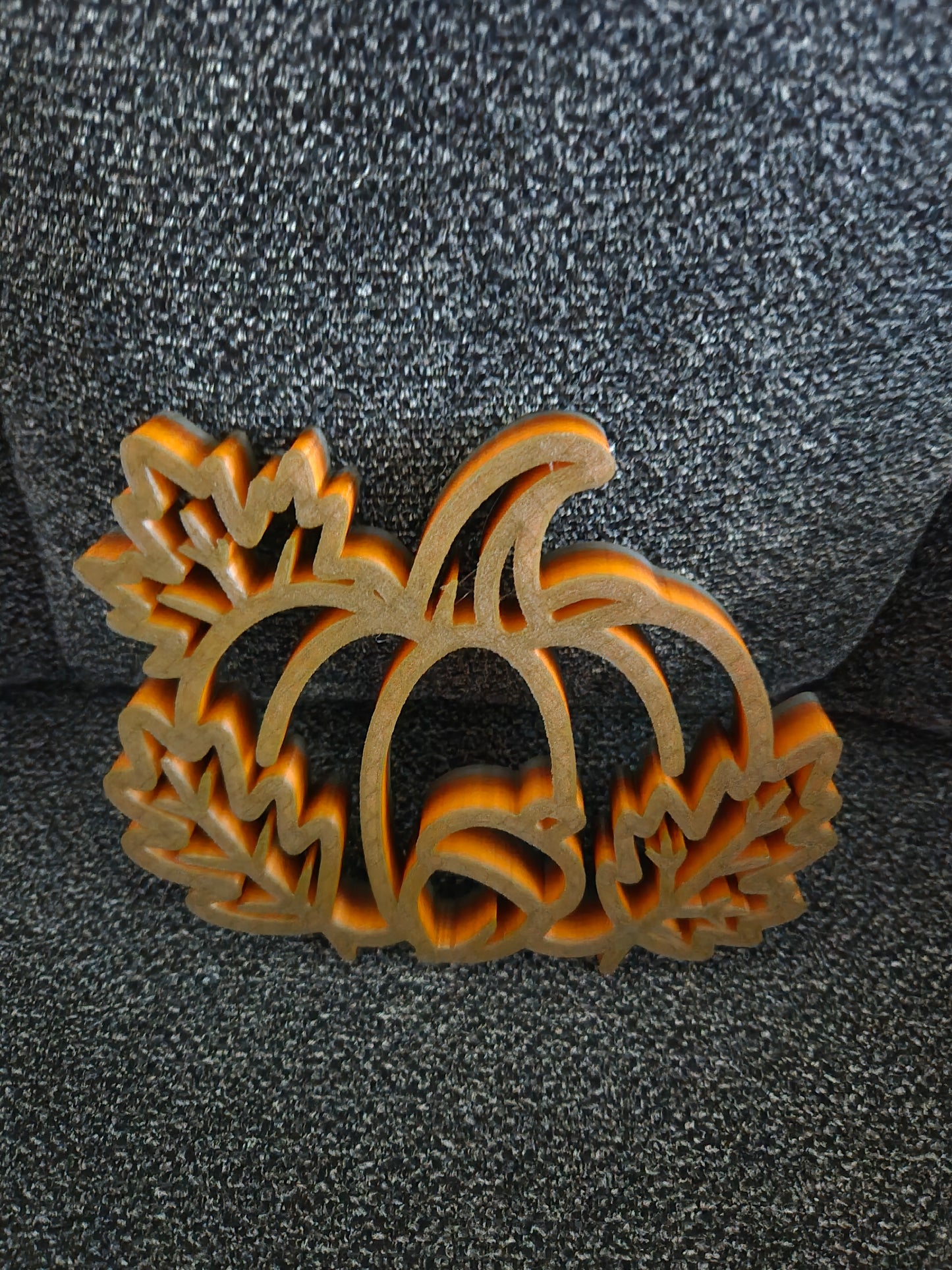 3D printed Pumpkin Harvest Scene in multicolor blended orange-to-gold filament, front view showing pumpkin with acorn and maple leaves open-frame silhouette